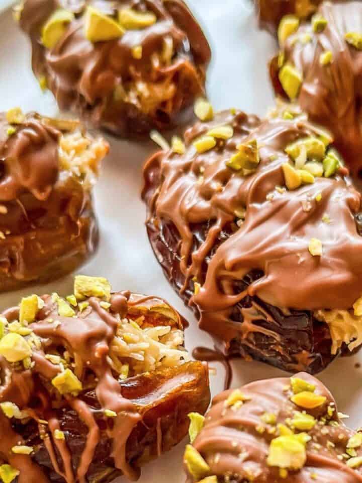Dubai chocolate dates covered in milk chocolate and chopped pistachios.