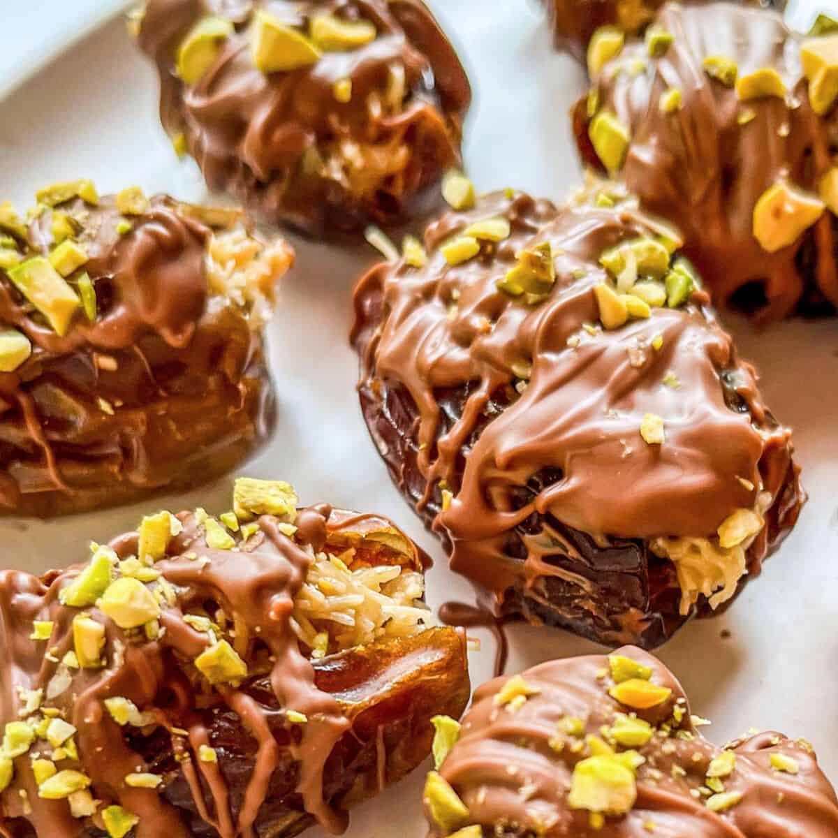 Dubai chocolate dates covered in milk chocolate and chopped pistachios.