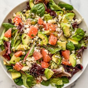 Grapefruit salad in a white bowl.