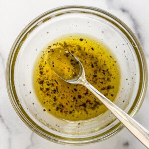 Honey citrus dressing mixed in a glass bowl.