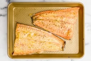 Baked mustard salmon on a sheet pan.