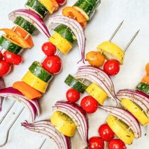 Veggies threaded onto metal skewers.