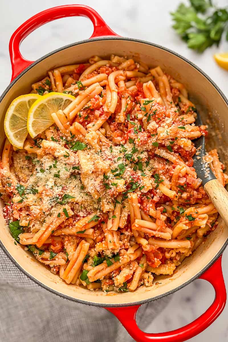 Pasta with pancetta and tomato sauce in a large pot.