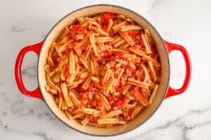 Cooked pasta with tomato pancetta sauce.