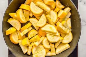 Chopped yellow squash in a pan.
