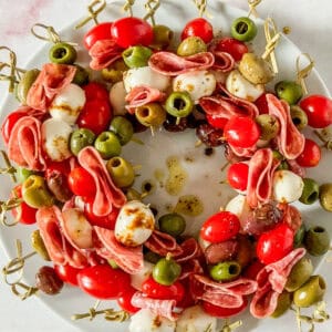 Antipasto skewers on a white plate.