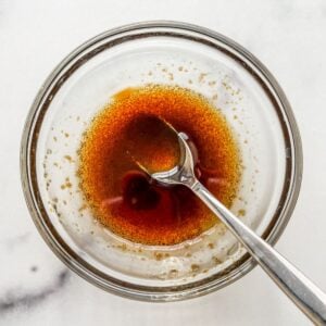 Balsamic and olive oil dressing in a glass bowl.