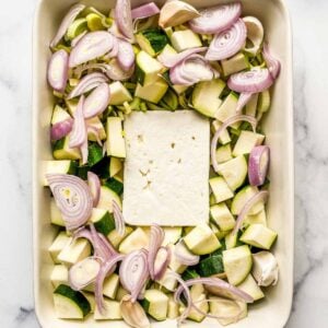 Zucchini, leeks, shallots, and feta in a baking dish.