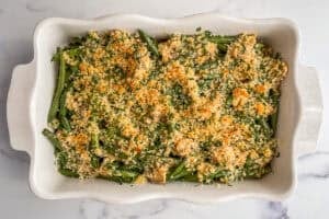 Healthy green bean casserole in a white baking dish.