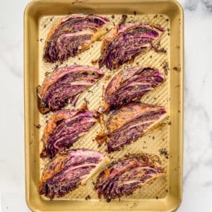 Roasted miso tahini cabbage wedges on a sheet pan.