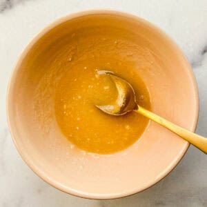 Marinade for honeynut squash in a small ceramic bowl.