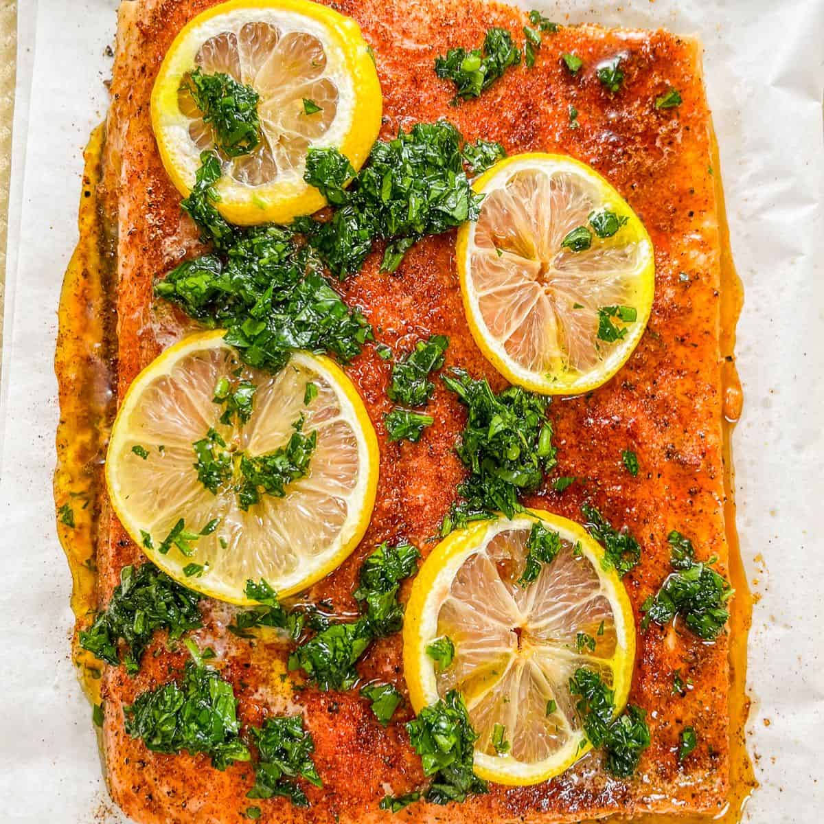 Slow roasted salmon topped with lemon slices and a cilantro sauce.