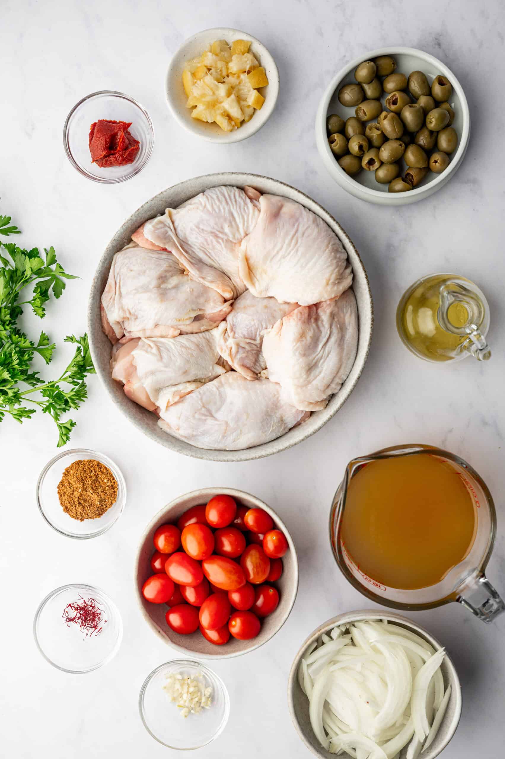 Ingredients for Moroccan chicken on a white background.