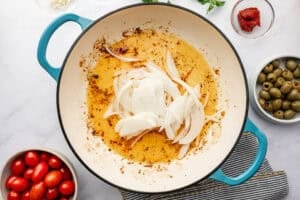 Onions being cooked in olive oil.