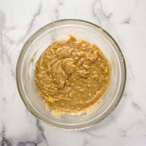 Cardamom citrus banana bread batter in a large glass mixing bowl.