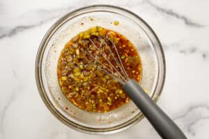 Bulgogi sauce in a white bowl with a whisk.