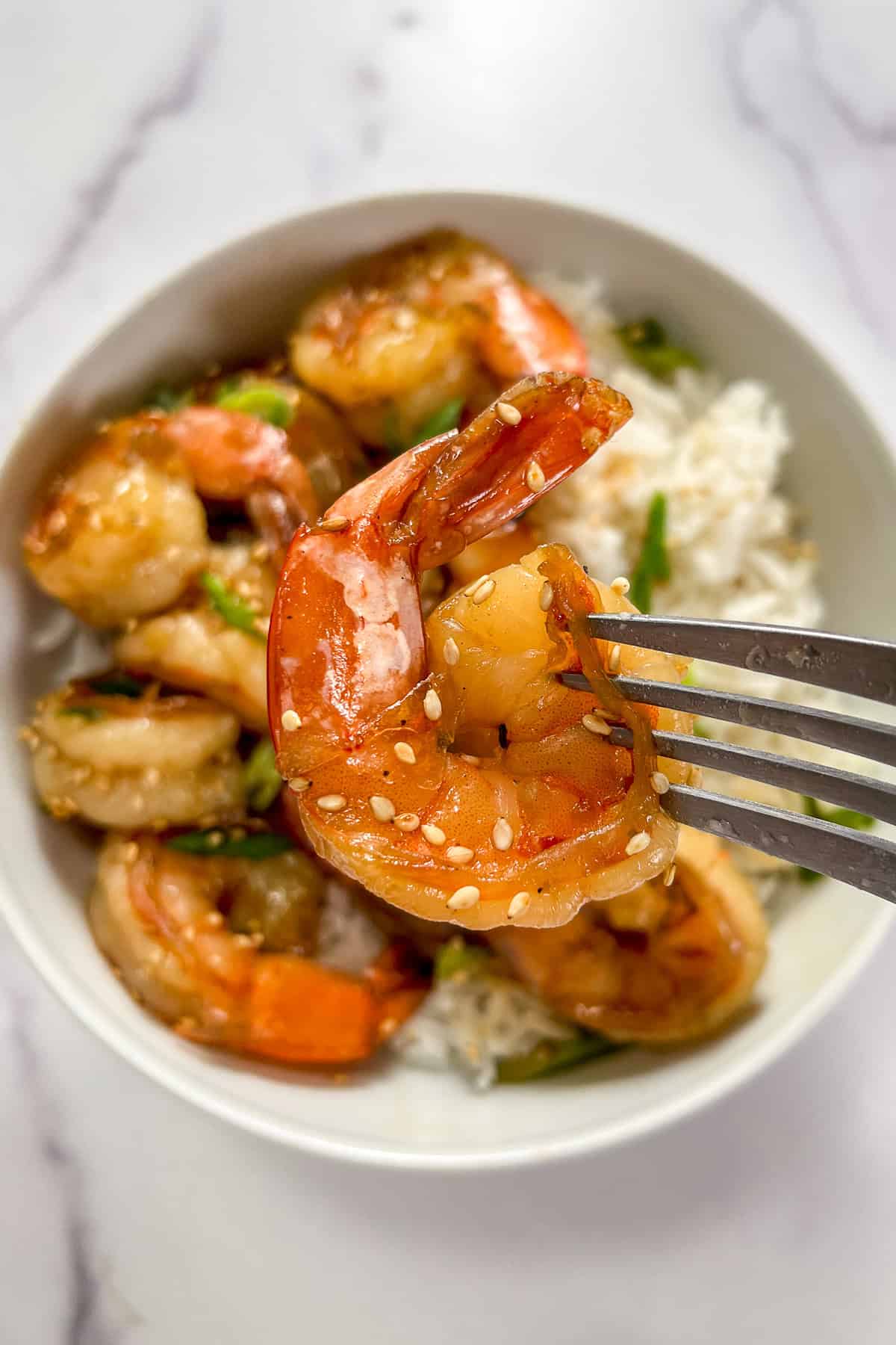 Honey garlic shrimp on a fork.