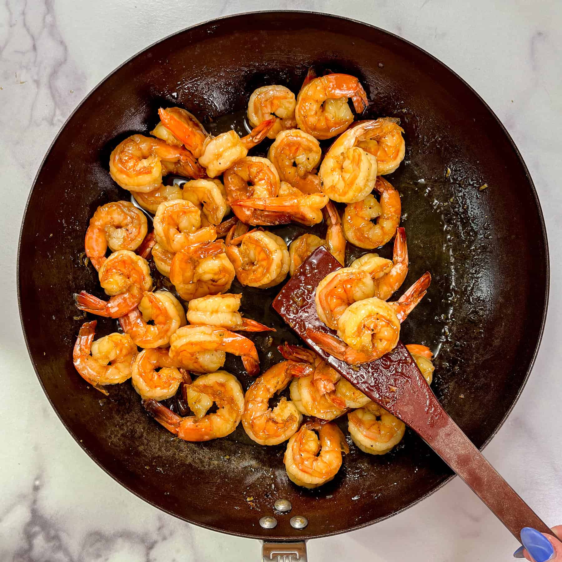 Soy honey garlic and shrimp being cooked in a frying pan.