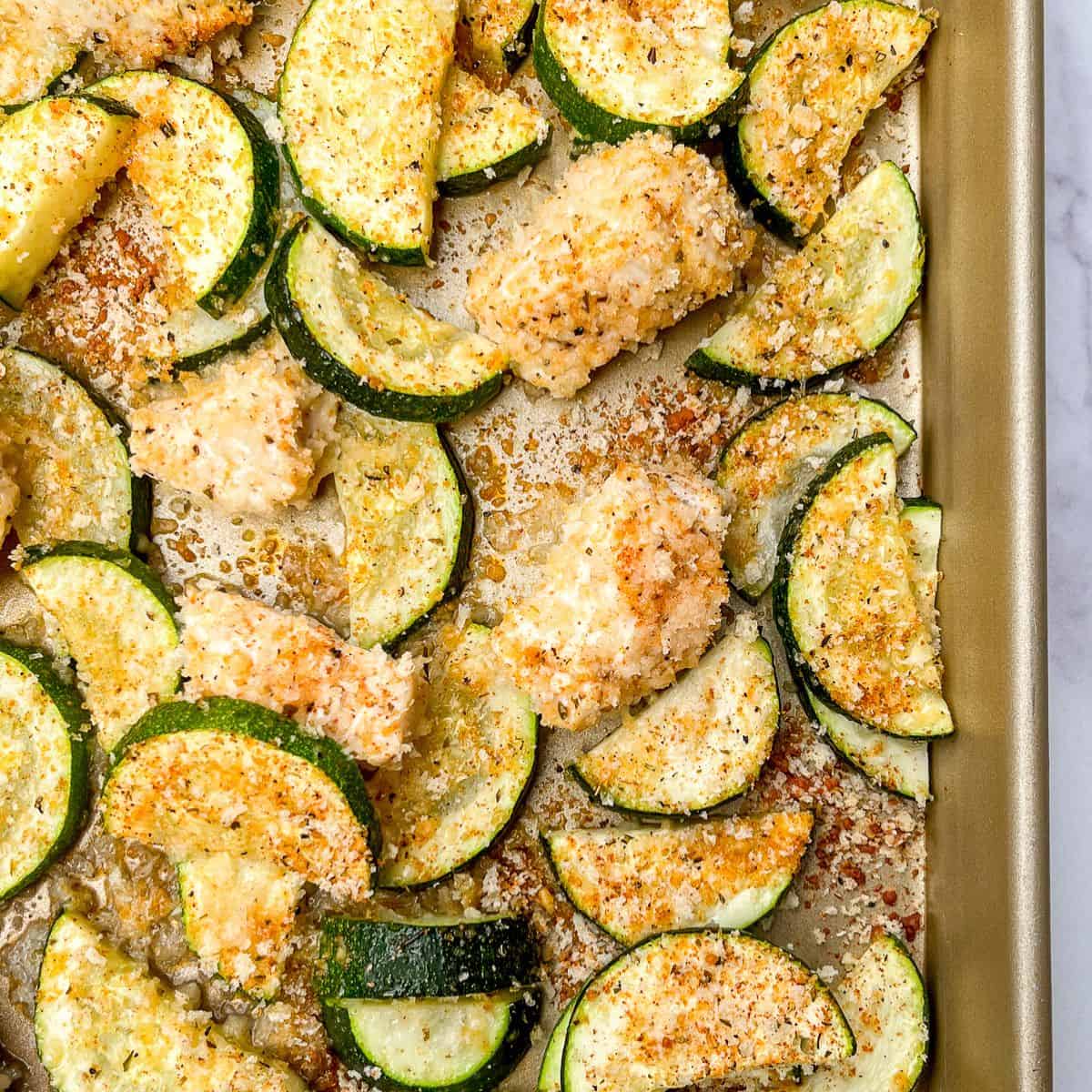 Crispy chicken and zucchini on a sheet pan.