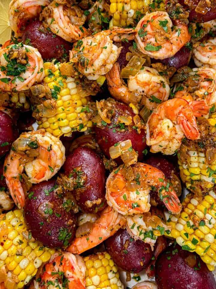 Cajun shrimp boil with red potatoes and corn on the cob.