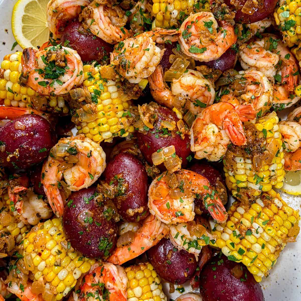 Cajun shrimp boil with red potatoes and corn on the cob.