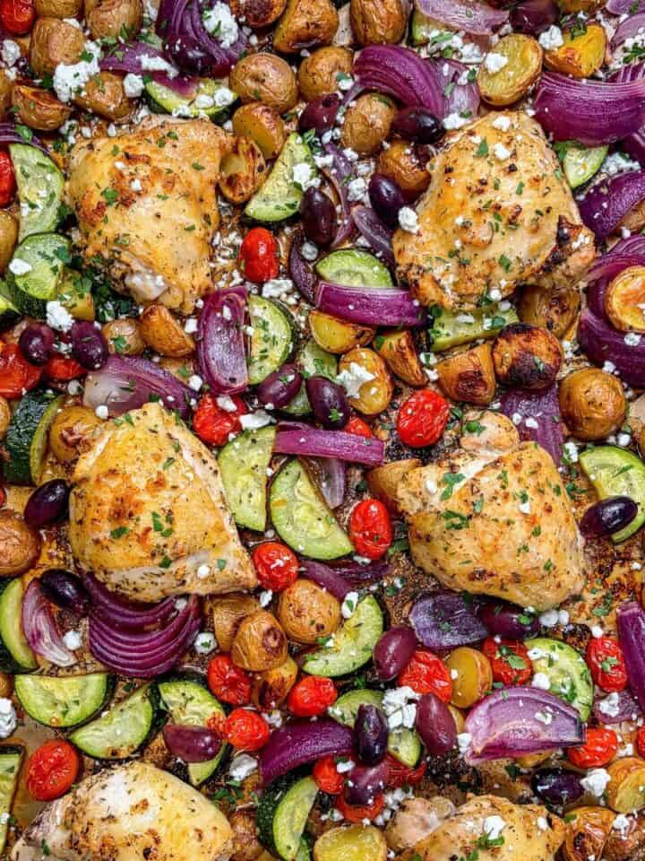 Sheet pan roasted Greek chicken thighs, potatoes, bell pepper, zucchini, and red onion.