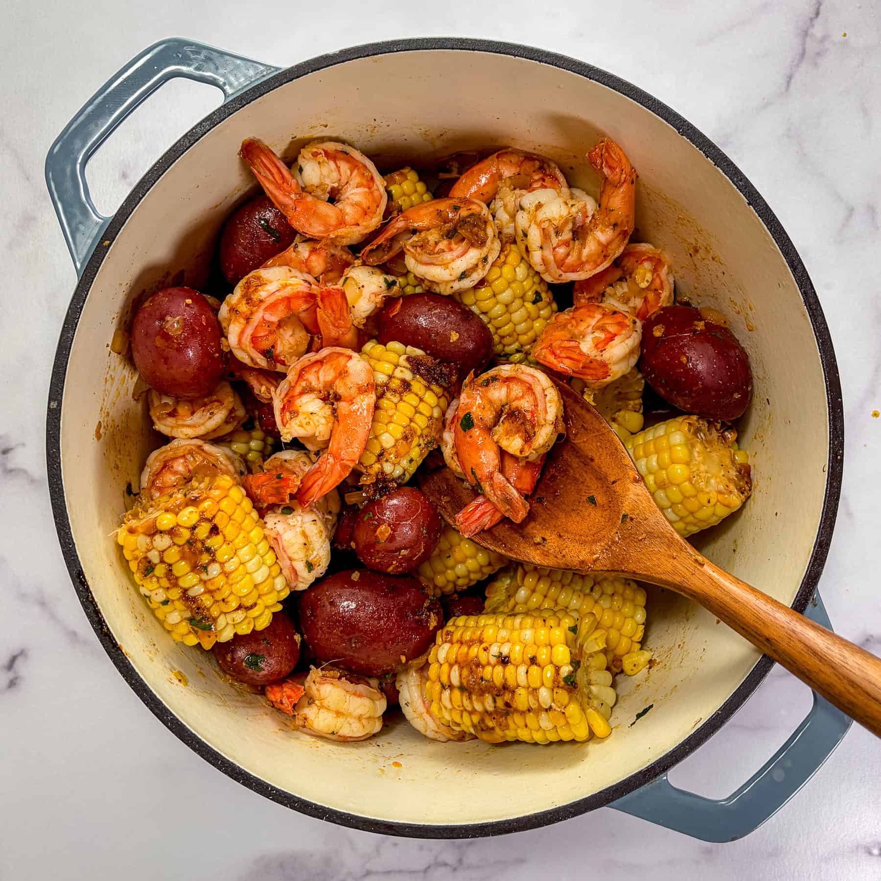 Shrimp seafood boil in a large pot.
